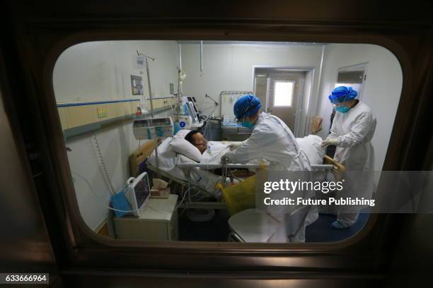 Medical staff help a patient infected by H7N9 bird flu on February 03, 2017 in Sichuan province, Suining, China. The health authority confirmed its...