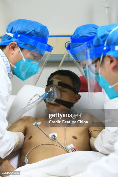 Medical staff help a patient infected by H7N9 bird flu on February 03, 2017 in Sichuan province, Suining, China. The health authority confirmed its...