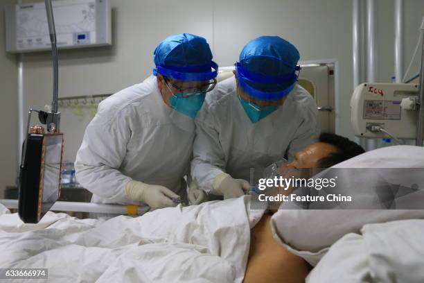 Medical staff help a patient infected by H7N9 bird flu on February 03, 2017 in Sichuan province, Suining, China. The health authority confirmed its...