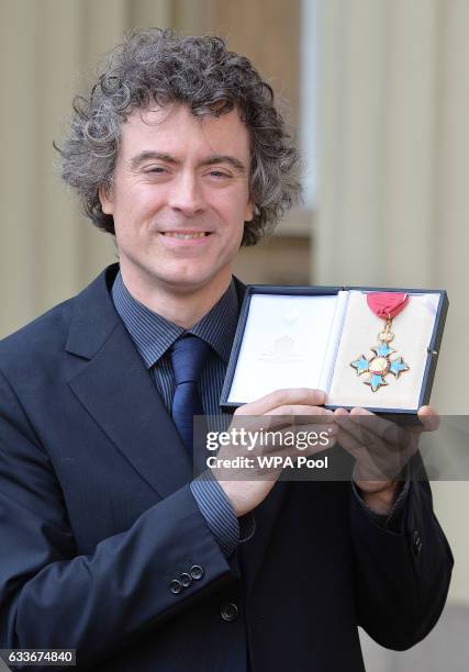 Classical pianist Paul Lewis poses after being awarded the Commander of the British Empire by the Prince of Wales at an Investiture ceremony at...