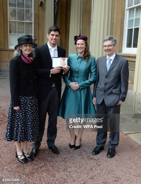 England cricket captain Alastair Cook poses with wife Alice, father Graham and mother Stephanie, after being awarded an CBE by the Prince of Wales at...