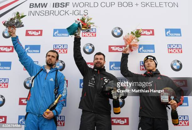 Alexander Tretiakov of Russia, Martins Dukurs of Latvia and Sungbin Yun of Korea celebrate after the Men's Skeleton final run of the BMW IBSF World...
