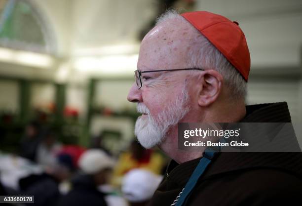 Cardinal Sean Patrick O'Malley visits the Pine Street Inn, and helps to serve up a Christmas Eve dinner, along with other volunteers, in Boston on...