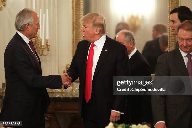 President Donald Trump greets Boeing Chairman James McNerney at the beginning of a policy forum in the State Dining Room at the White House February...