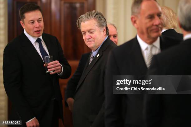 SpaceX and Tesla CEO Elon Musk talks with White House Chief Strategist Steve Bannon at the beginning of a policy forum with U.S. President Donald...