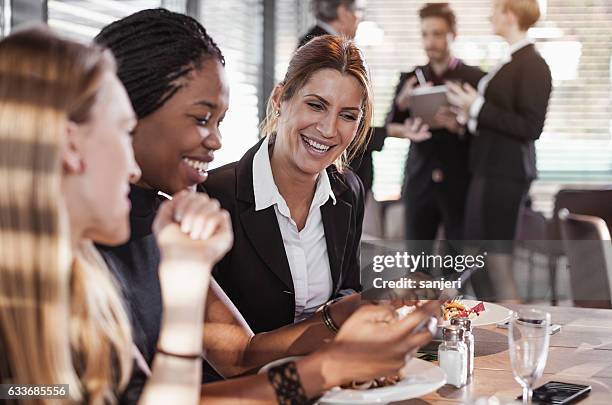 business people having a meal at a cafe restaurant - businesswoman hotel stock pictures, royalty-free photos & images