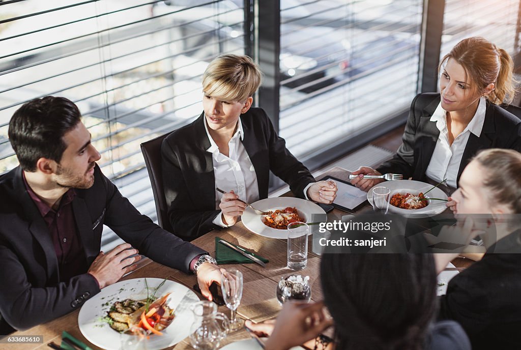 Business People Having a Meal at a Cafe Restaurant