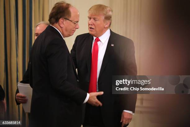 President Donald Trump greets BlackRock CEO Larry Fink at the beginning of a policy forum in the State Dining Room at the White House February 3,...