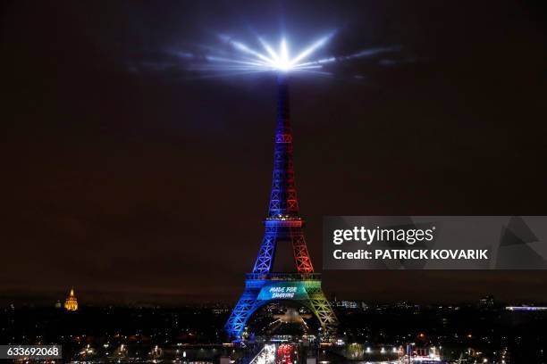 Picture shows the Eiffel Tower lit in the colours of the Olympic flag during the launch of the international campaign for Paris' bid to host the 2024...