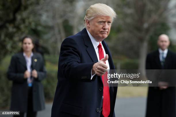 President Donald Trump gives a thumbs-up to members of the news media before boarding Marine One and departing the White House February 3, 2017 in...
