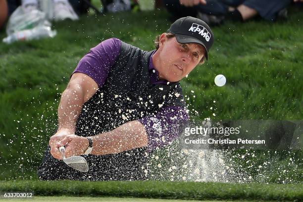 Phil Mickelson chips from the bunker onto the ninth green during the second round of the Waste Management Phoenix Open at TPC Scottsdale on February...
