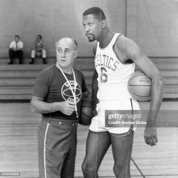 Boston Celtics coach Red Auerbach, left, talks to player Bill Russell during practice at Babson College in Wellesley, Mass., on Sept. 13, 1965.
