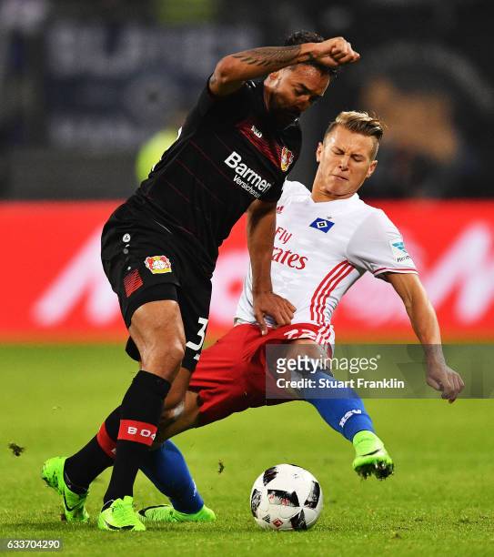Karim Bellarabi of Bayer Leverkusen is challenged by Matthias Ostrzolek of Hamburger SV during the Bundesliga match between Hamburger SV and Bayer 04...