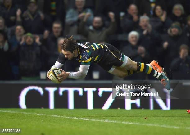 Ben Foden of Northampton Saints dives in to score their third try during the Anglo-Welsh Cup match between Northampton Saints and Scarlets at...