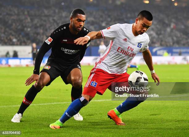 Bobby Wood of Hamburger SV is tracked by Jonathan Tah of Bayer Leverkusen during the Bundesliga match between Hamburger SV and Bayer 04 Leverkusen at...