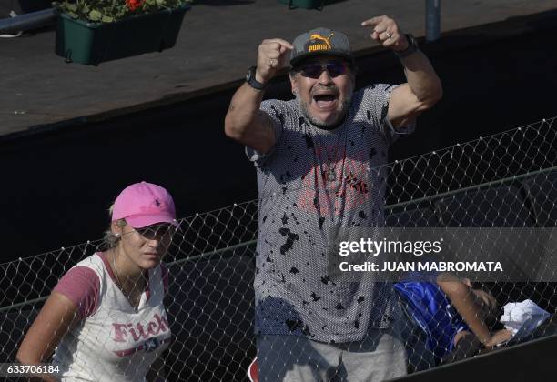 Argentine football legend Diego Maradona cheers nexto his girlfiend Rocio Oliva and his grandson Benjamin Aguero during the 2017 Davis Cup World...