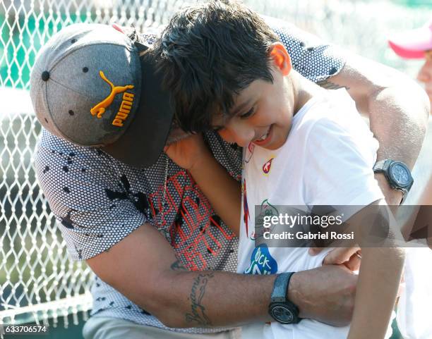 Former player Diego Maradona with his grandchild Benjamin Aguero are seen during a singles match between Carlos Berlocq and Andreas Seppi as part day...