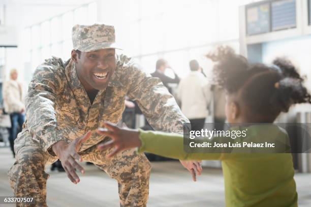 returning soldier greeting daughter - military airfield stock pictures, royalty-free photos & images