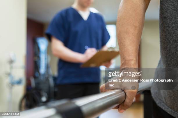 patient having physical therapy in hospital - rehabilitation krankheit stock-fotos und bilder