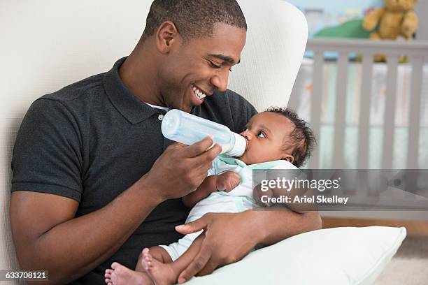 black father feeding baby son - baby bottle ストックフォトと画像