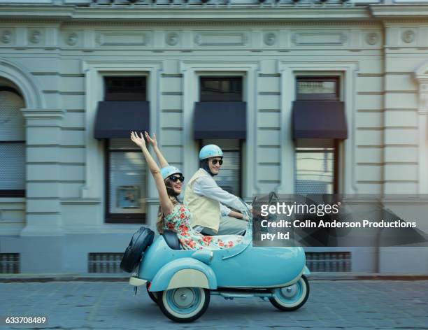 couple driving vintage scooter and sidecar - couple traveler fotografías e imágenes de stock