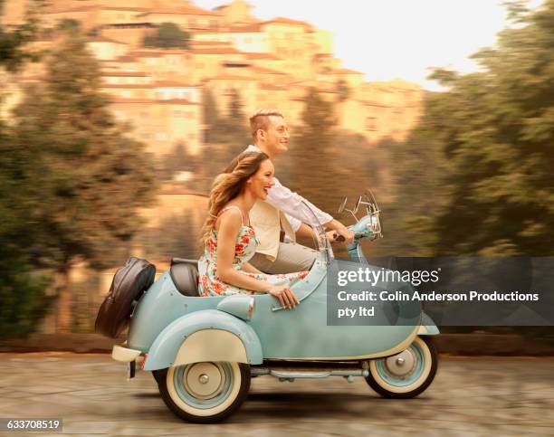 couple driving vintage scooter with sidecar - motorbike sidecar stock pictures, royalty-free photos & images