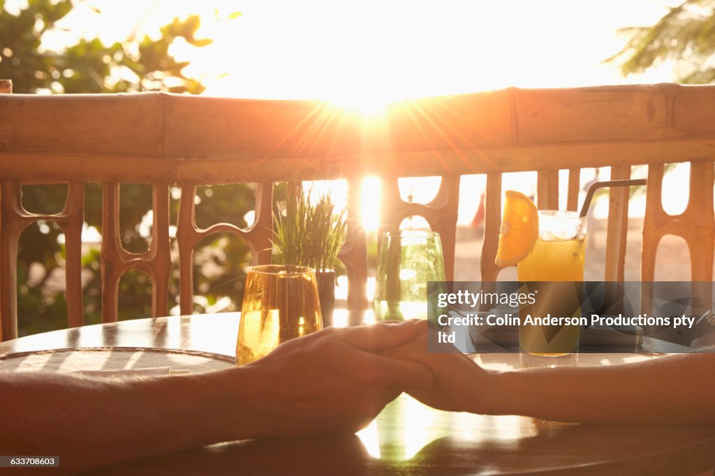 Couple holding hands on patio