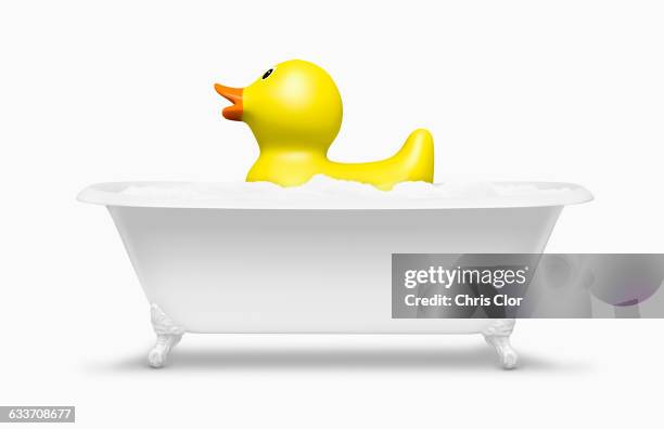 rubber duck floating in bath - 据え置き型バスタブ ストックフォトと画像