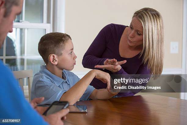 caucasian mother signing with deaf son - american sign language stock pictures, royalty-free photos & images