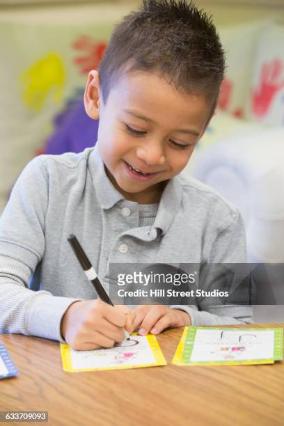 mixed race student drawing in classroom - flash card stock pictures, royalty-free photos & images