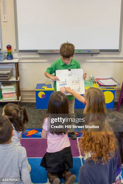 student giving presentation in classroom - boy in briefs stock pictures, royalty-free photos & images