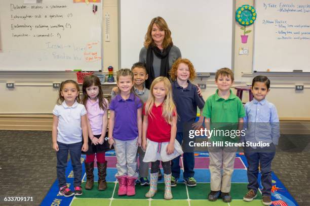 students and teacher smiling in classroom - photography studios stockfoto's en -beelden