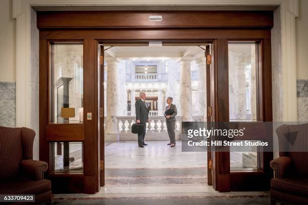 caucasian politicians talking in capitol building - us federal trade commission stock pictures, royalty-free photos & images