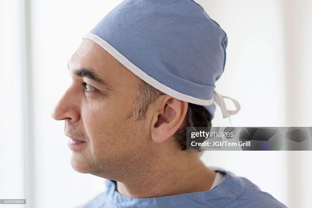 Mixed race surgeon wearing scrubs