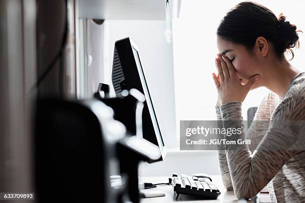 hispanic woman using computer - stress at work stock pictures, royalty-free photos & images