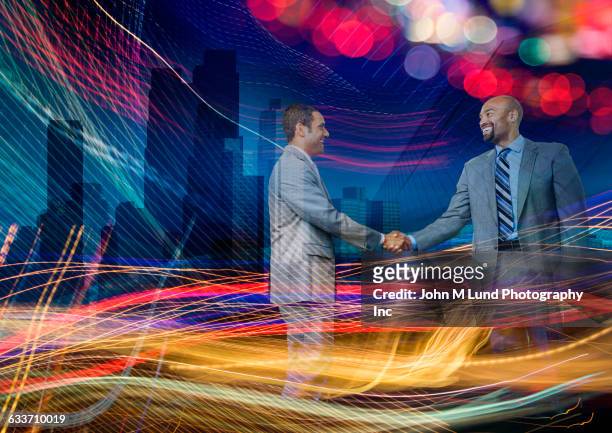 double exposure of business people shaking hands in light stream - two international finance center stock pictures, royalty-free photos & images