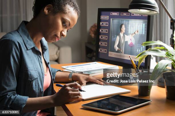 mixed race student taking online class on computer - mixed age range stock-fotos und bilder