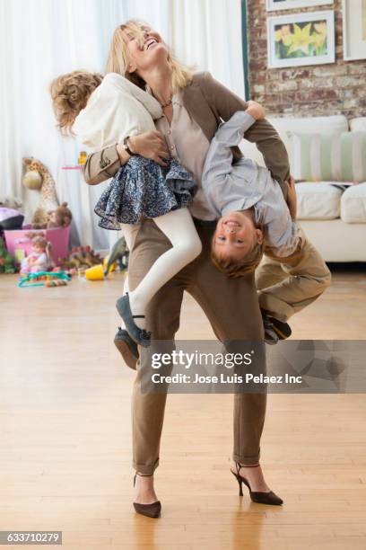 caucasian working mother playing with children - family with two children stock pictures, royalty-free photos & images