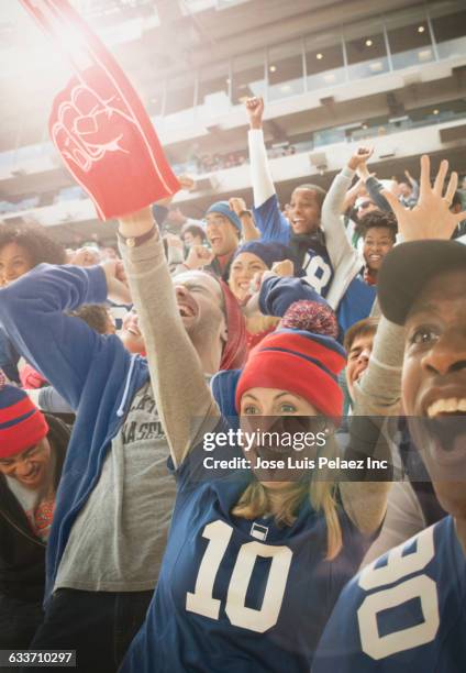 sports fans cheering in stadium - blonde cheering stock-fotos und bilder