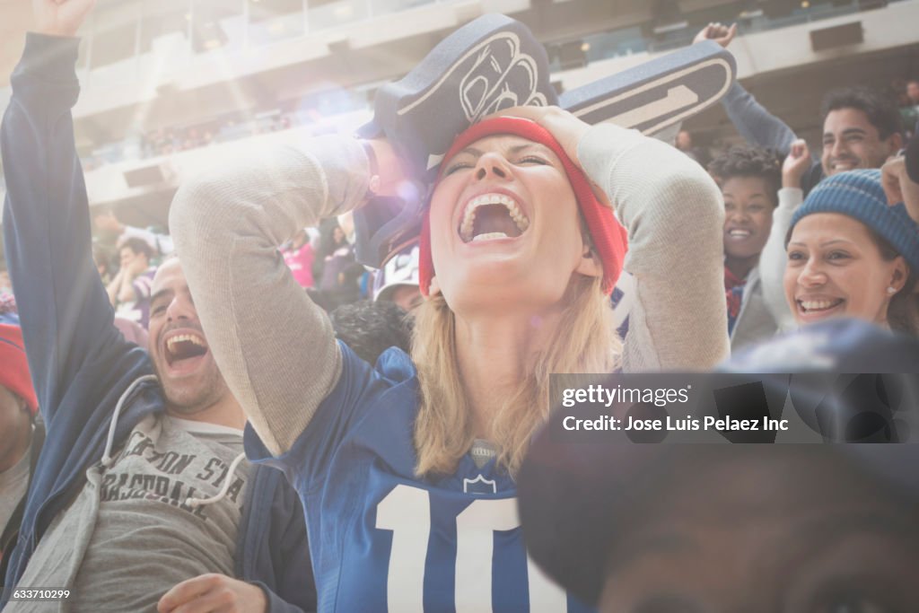 Sports fan cheering in stadium