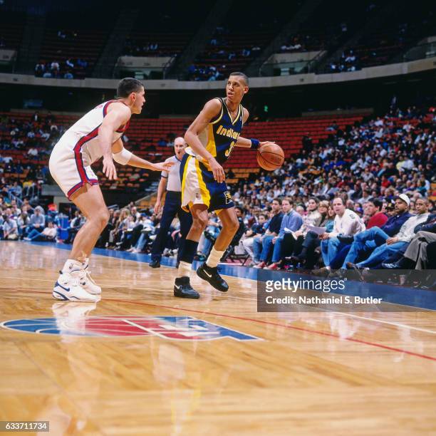 Reggie Miller of the Indiana Pacers dribbles against Drazen Petrovic of the New Jersey Nets during a game played circa 1993 at the Brendan Byrne...