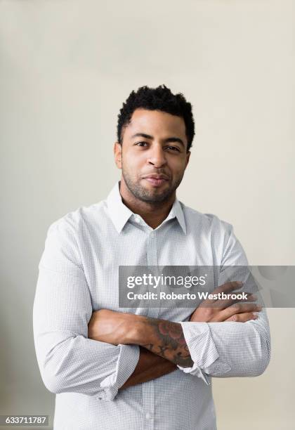 african american businessman smiling with arms crossed - real businessman isolated no smile stock pictures, royalty-free photos & images