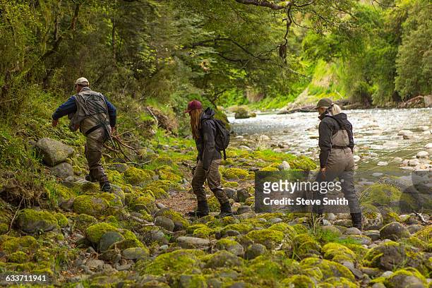 caucasian friends walking in remote river - new zealand cup day 3 stock pictures, royalty-free photos & images