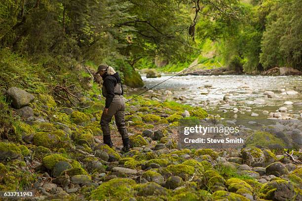 caucasian woman walking in remote river - awards arrivals stock pictures, royalty-free photos & images