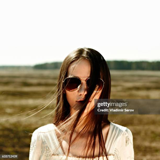 caucasian woman standing in rural field - woman with straight hair stock pictures, royalty-free photos & images