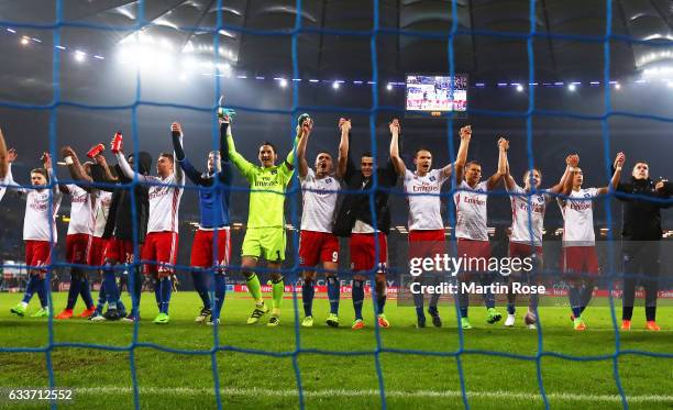 Kyriakos Papadopoulos and Rene Adler of Hamburger SV celebrate with team mates after victory in the Bundesliga match between Hamburger SV and Bayer...