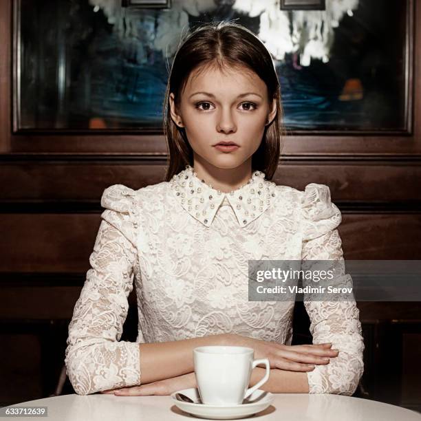 caucasian teenage girl drinking coffee in restaurant - vintage lace stock pictures, royalty-free photos & images