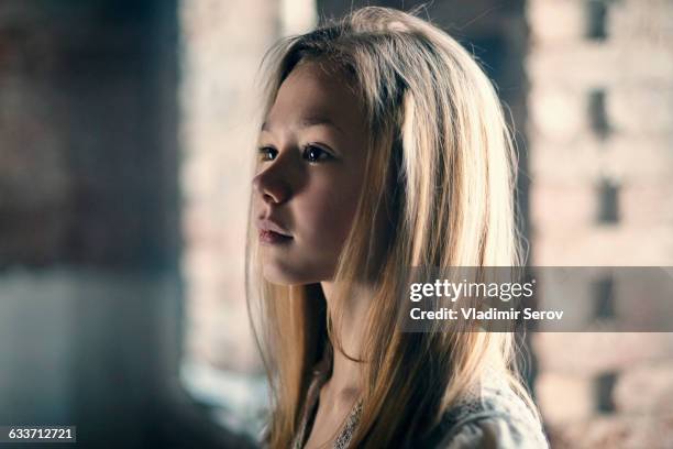 caucasian girl standing at window - 12 year old blonde girl stock pictures, royalty-free photos & images