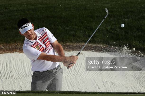 Louis Oosthuizen of South Africa chips from the bunker onto the 12th green during the second round of the Waste Management Phoenix Open at TPC...