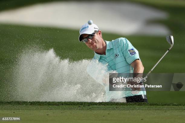 David Hearn of Canada chips from the bunker onto the 11th green during the second round of the Waste Management Phoenix Open at TPC Scottsdale on...